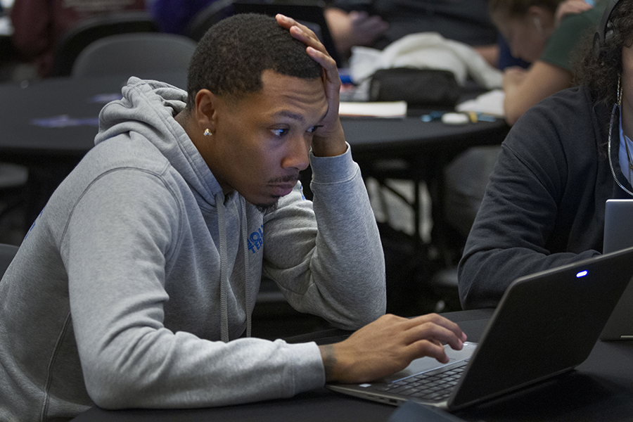 A student works on a laptop.