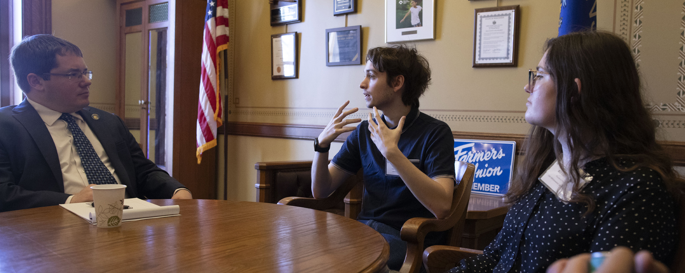 A psychology student talks with a senator at the Wisconsin State Capitol.