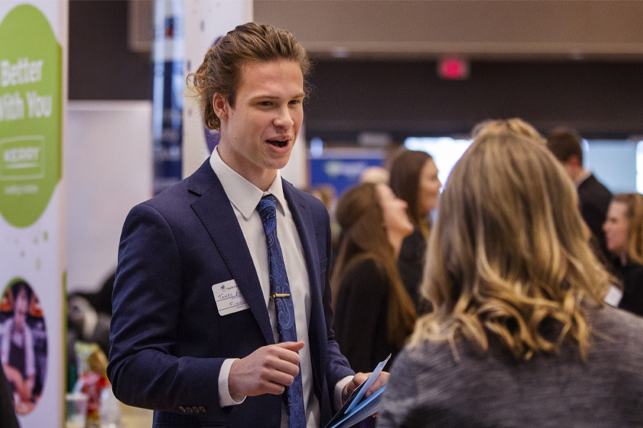 A student speaks with an employer at the career fair.