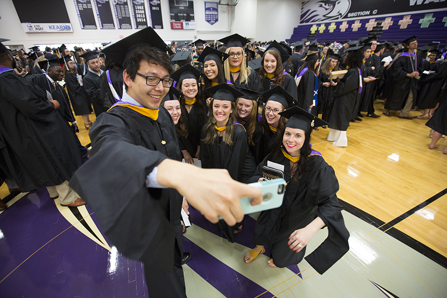 Students gather for a selfie at Commencement.