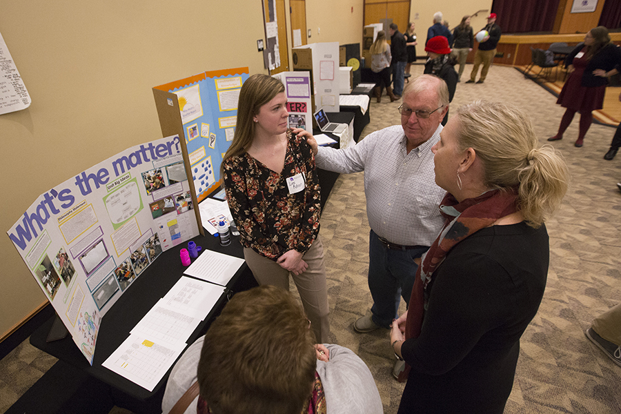 A student displays their lesson plan on a board.