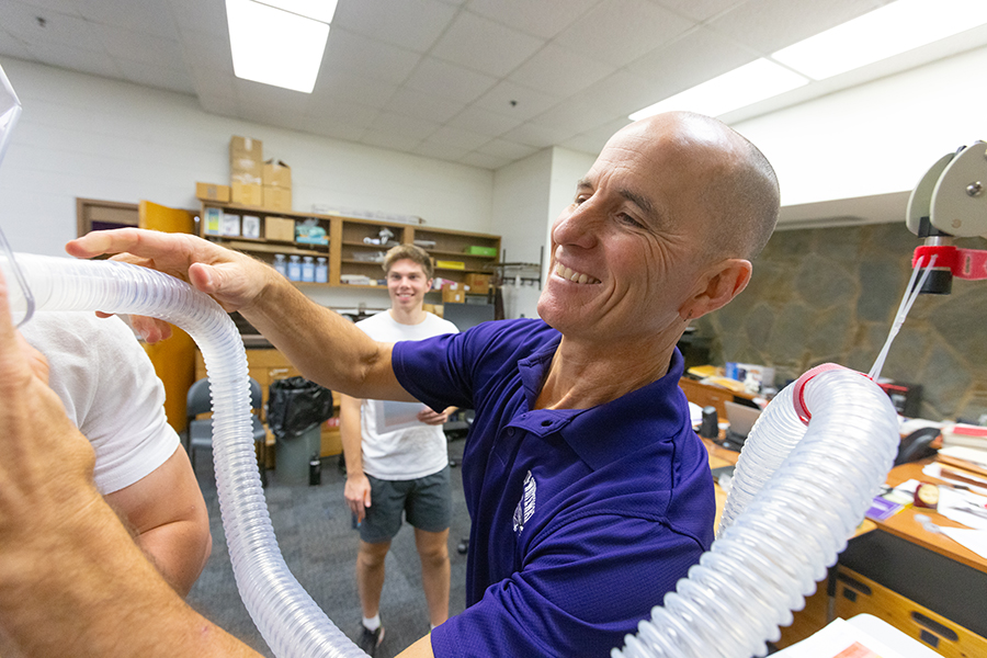 A faculty member shows equipment in the kinesiology lab.