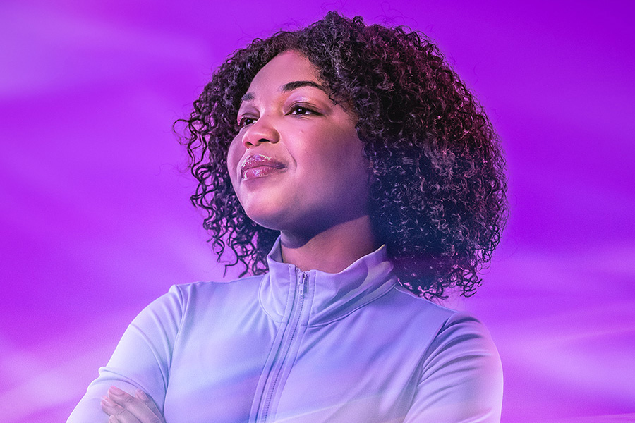 A person smiles as they look off camera. 