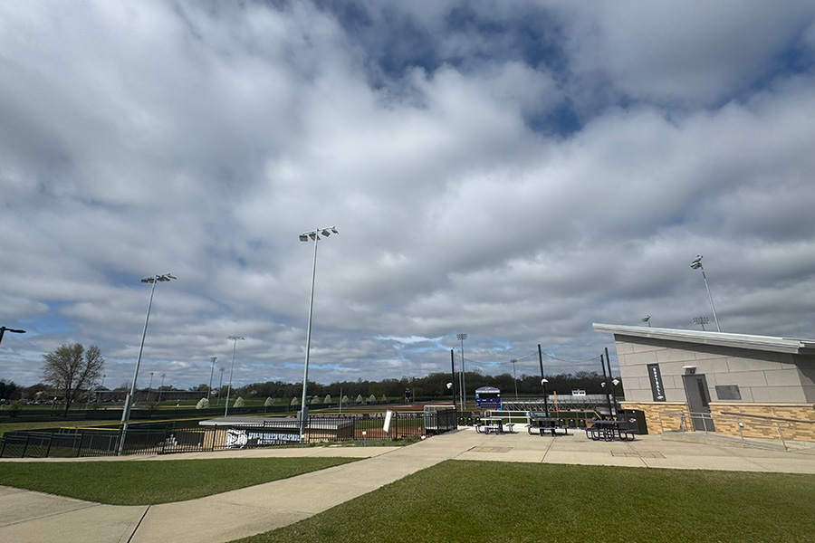Lighting at the softball field on the UW-Whitewater campus with clouds in a blue sky