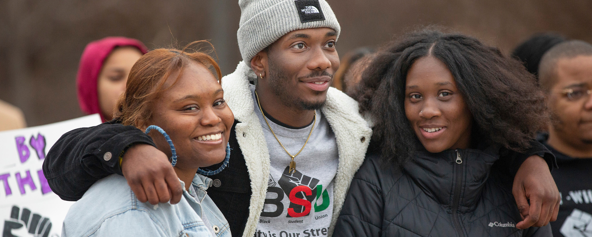Group of black student union students smiling and hugging