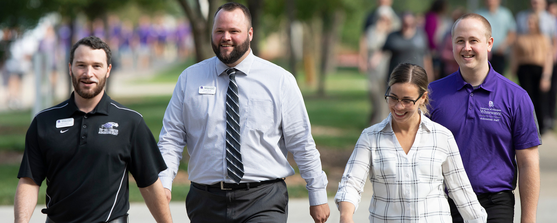 Group of smiling people walking outside at UW-Whitewater