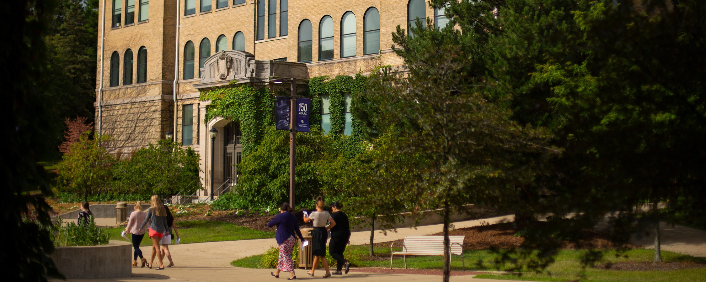 Picture of people walking in front of Hyer Hall on UW-Whitewater campus