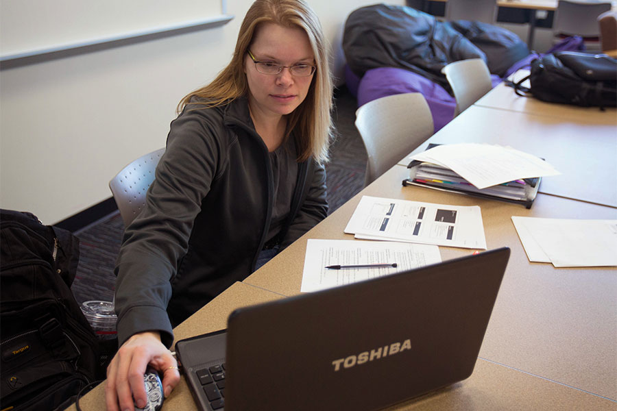  Adult student works on laptop.