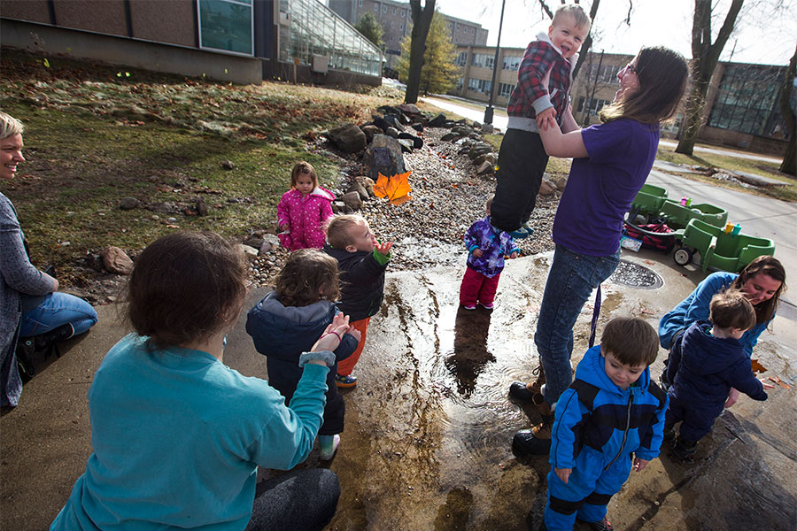  Teachers and children from the UW-Whitewater Children's Center pause on the South Mall by Upham Hall.