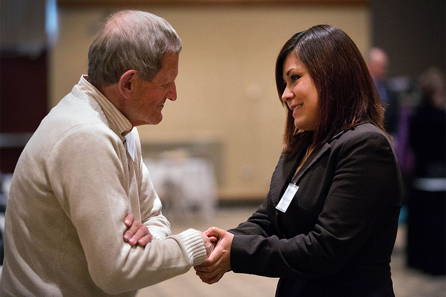  Two people shaking hands on the UW-Whitewater campus.