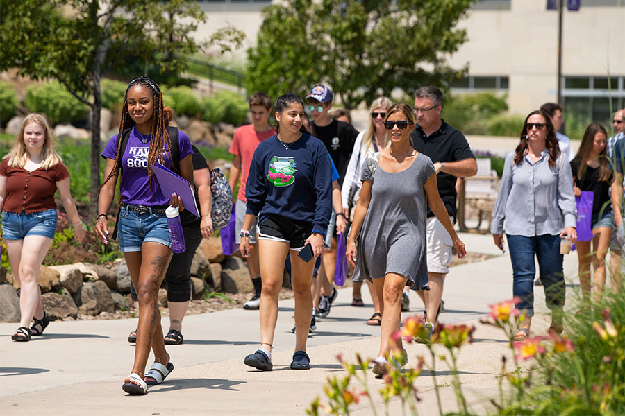 A Hawk Squad member leads a tour on the UW-Whitewater campus.