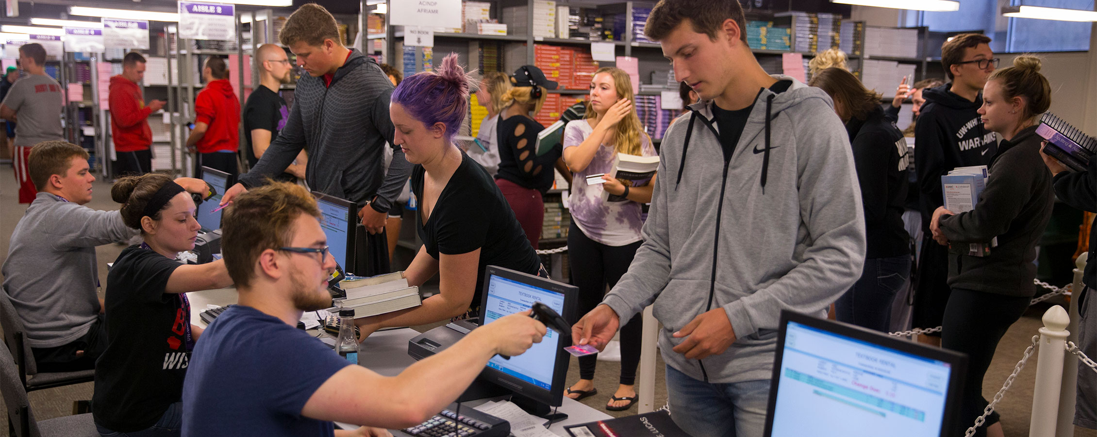 Students check out textbooks on the lower level of the UW-Whitewater bookstore.