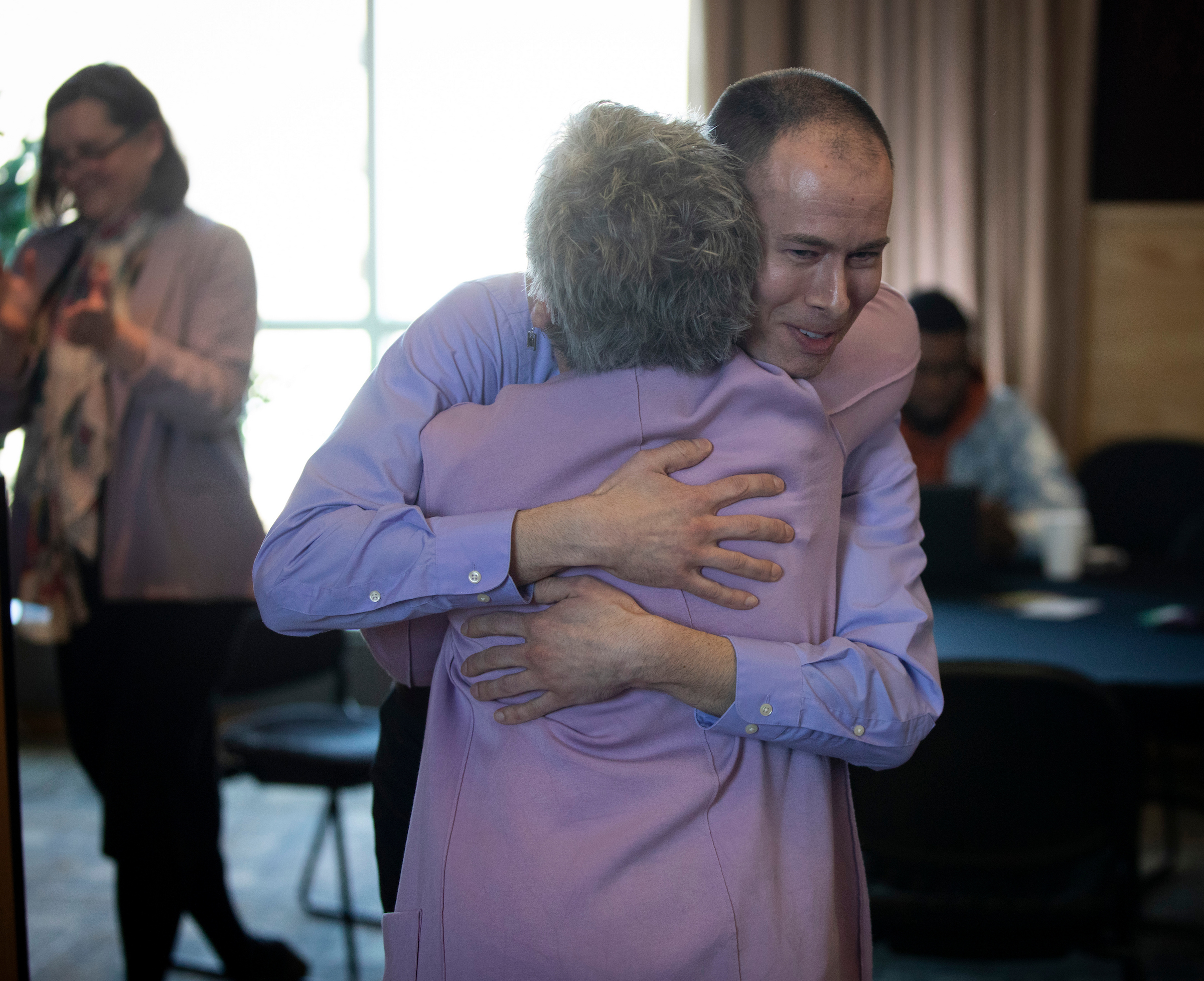 Jeff Angileri hugs another person.