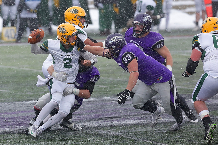 A Warhawk defensive lineman reaches for the opposing quarterback.