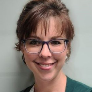 Headshot of Cody Busch wearing glasses and a green shirt