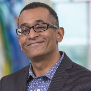 Headshot of K. Praveen Parboteeah wearing a suit coat and smiling in Hyland Hall