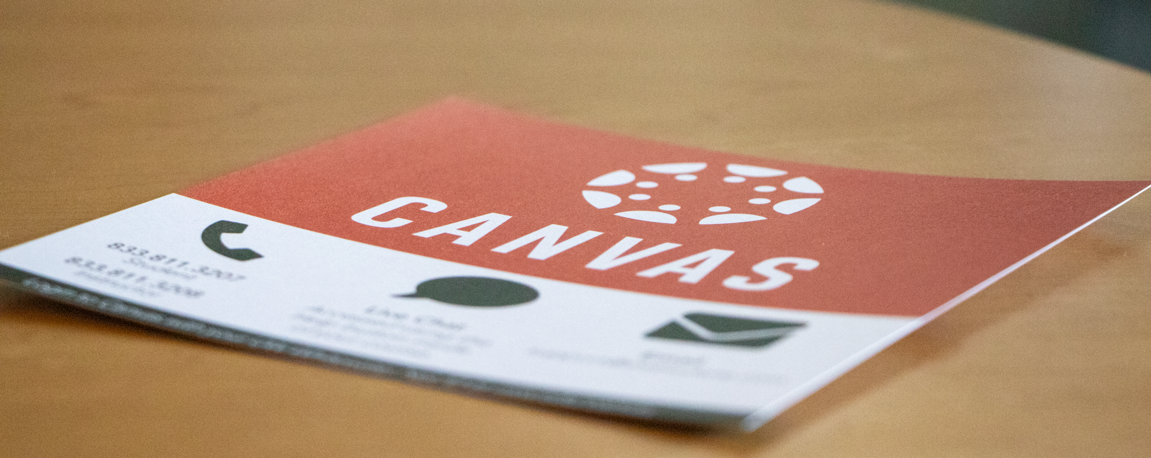 A Canvas branded handout rests on a wooden surface