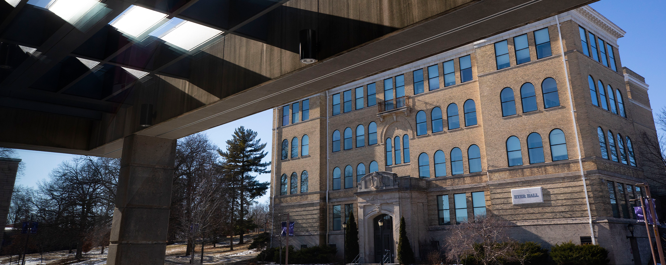 Light reflects from McGraw Hall in the foreground as Hyer Hall contrasts with its more modern style