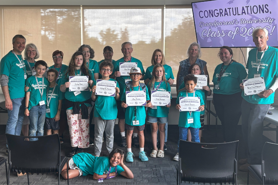 Kids and Grandparents holding their Grandparents University® degree.