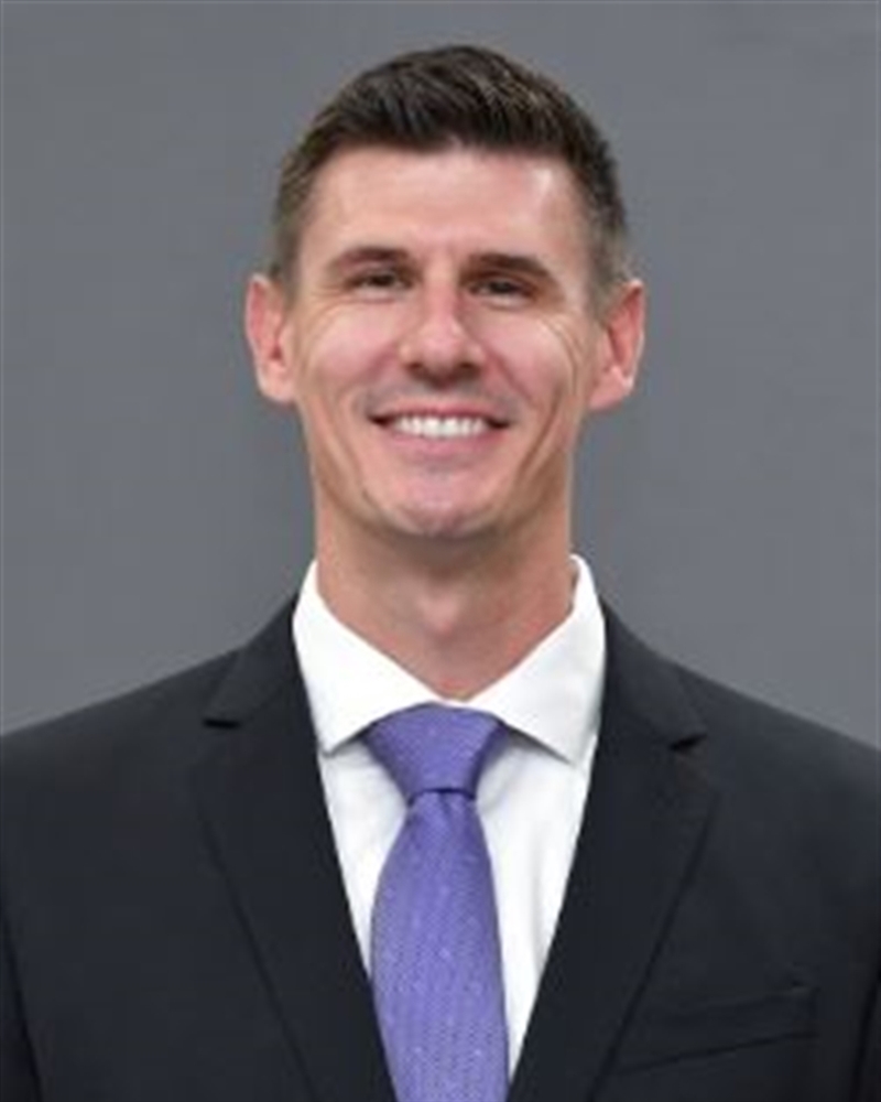 Head coach smiles for a photo