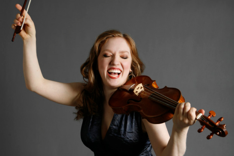 Rachel Pine lays with violin in hand | Photo downloaded from Rachel Pine Press Release Kit