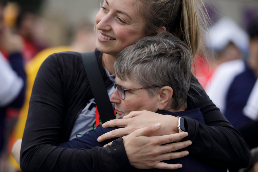 UW Whitewater Impact To Community as community memebers hug