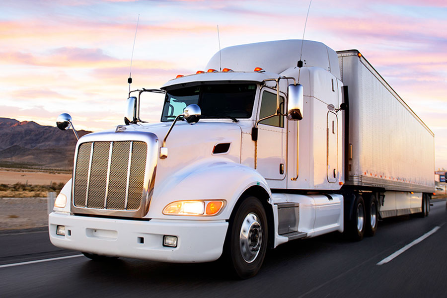 Freight truck driving down a highway