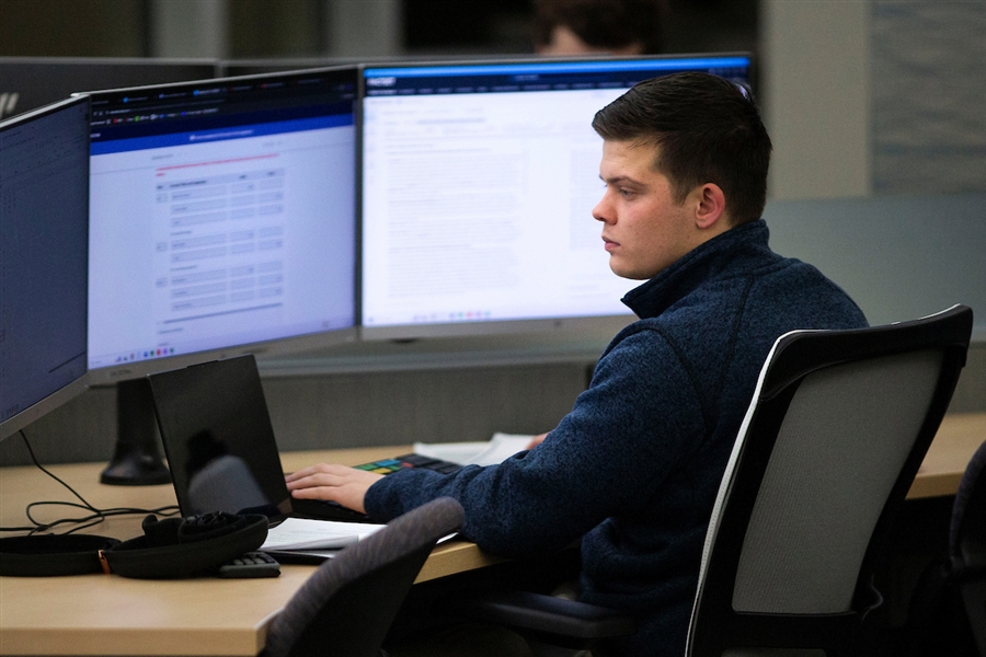 Studnet working on a computer in the Hyland Hall