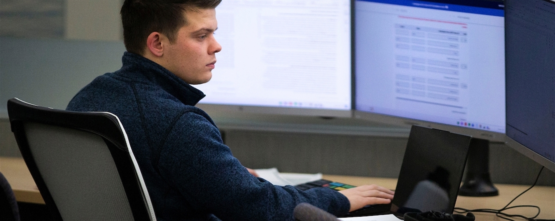Student working on a computer in Hyland Hall