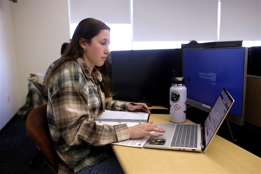 Studnet working on a computer in the Hyland Hall