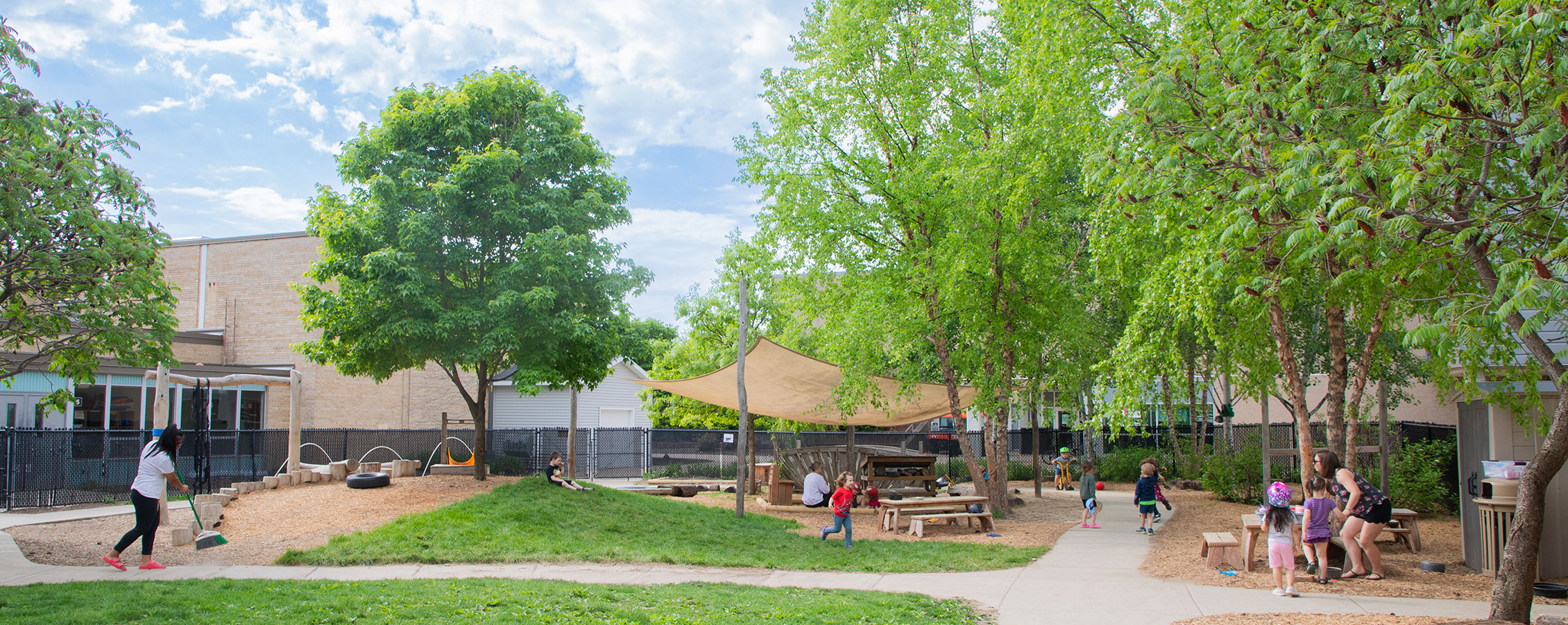 Outdoors at the UW-Whitewater Children's Center with students and teachers playing.