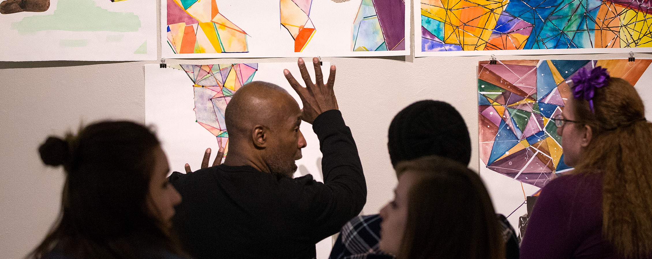 Nick Cave discusses artwork with students during his visit