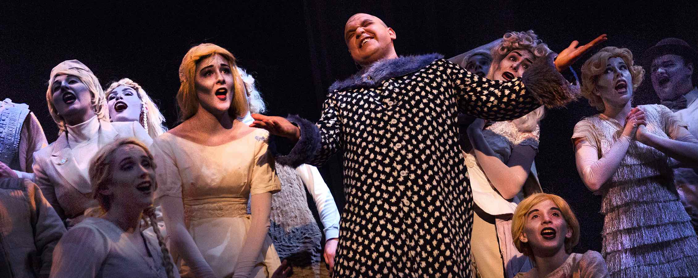 Nahuel Recoba, a music major from DeForest, shines as Uncle Fester, here surrounded by Addams family ghosts. The Addams Family Musical is this year's spring production, an annual collaboration between the theatre/dance and music departments.