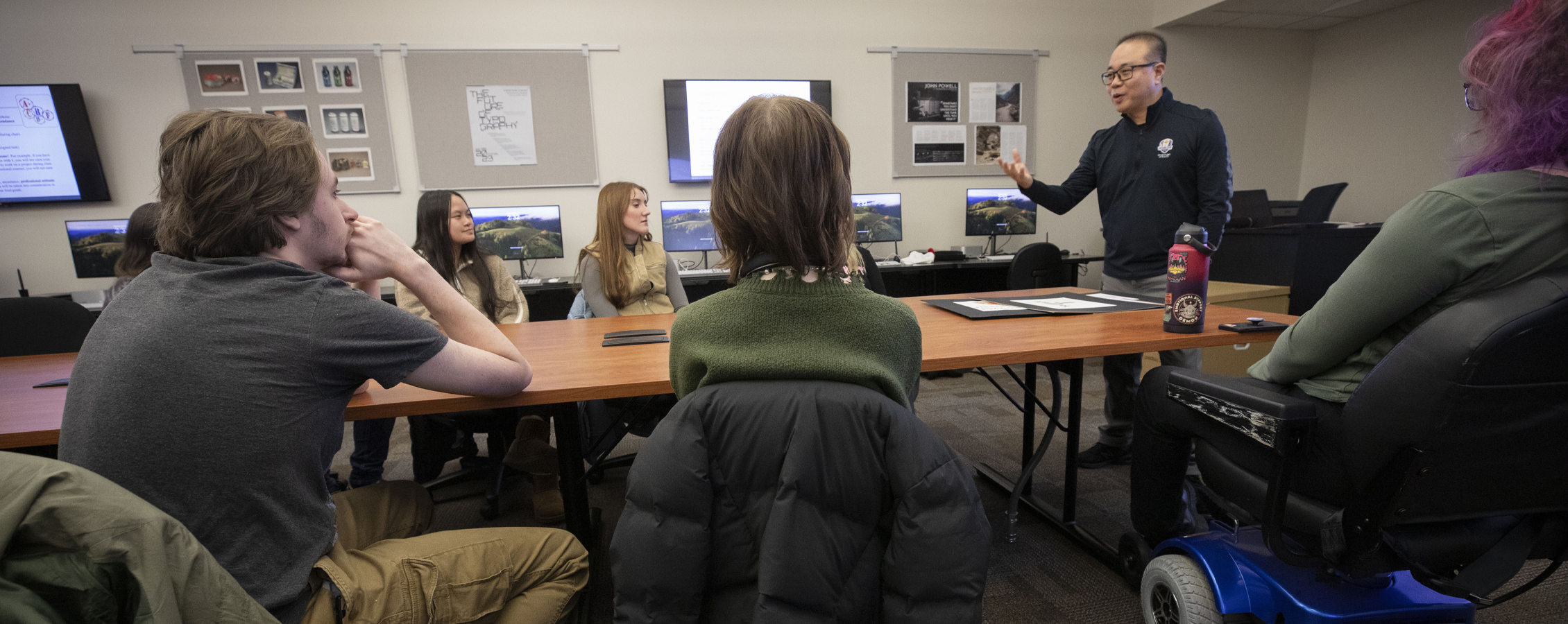 Media arts and game development student explains her class project in the studio on the University of Wisconsin Whitewater campus.