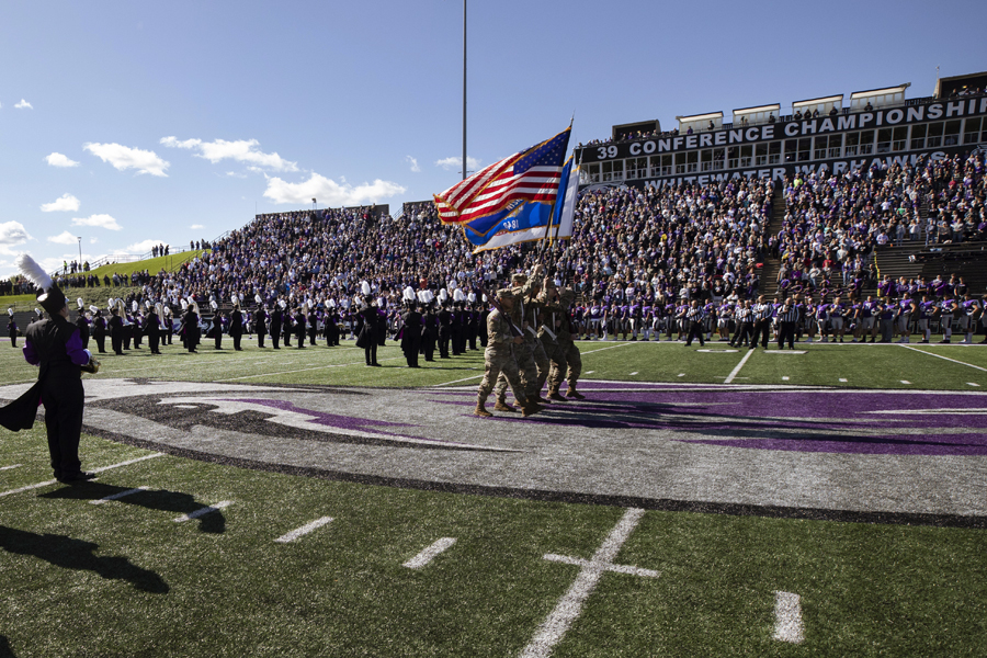 The Marching Band performs in front of a large crowd at Perkins Stadium.