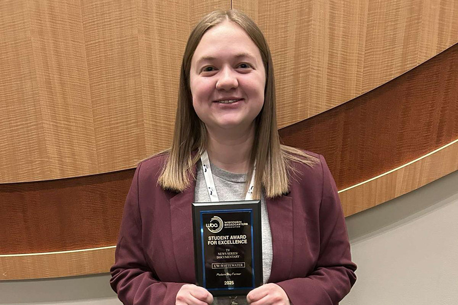 Emma Gailloto stands with her plaque she was awarded.