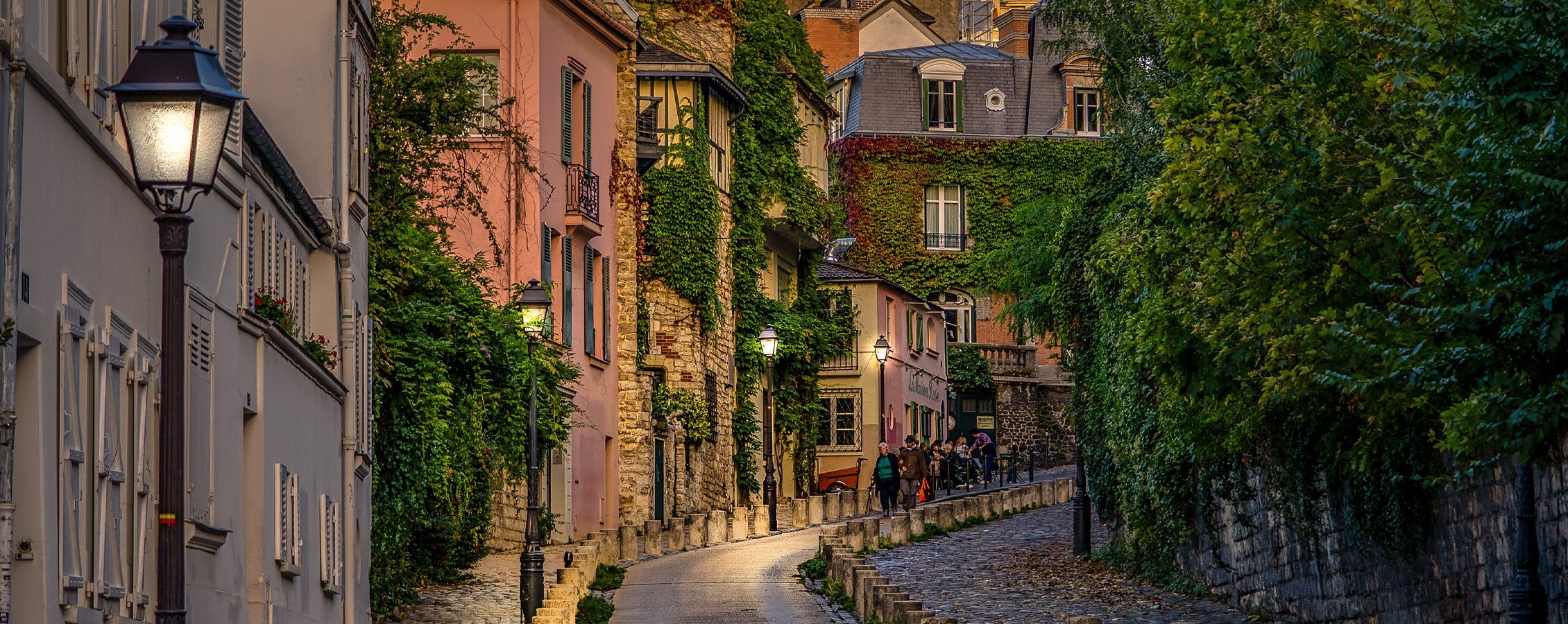 Streets of a European city with vines growing on the buildings.