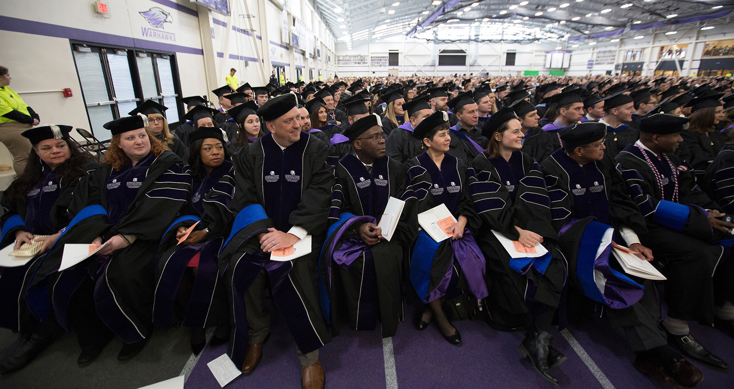 Members of the second DBA cohort wait to accept their degrees at winter commencement on Dec. 15, 2018.