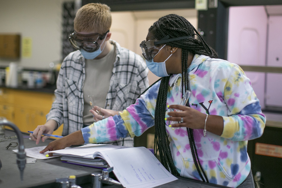 Two students work in a science lab.