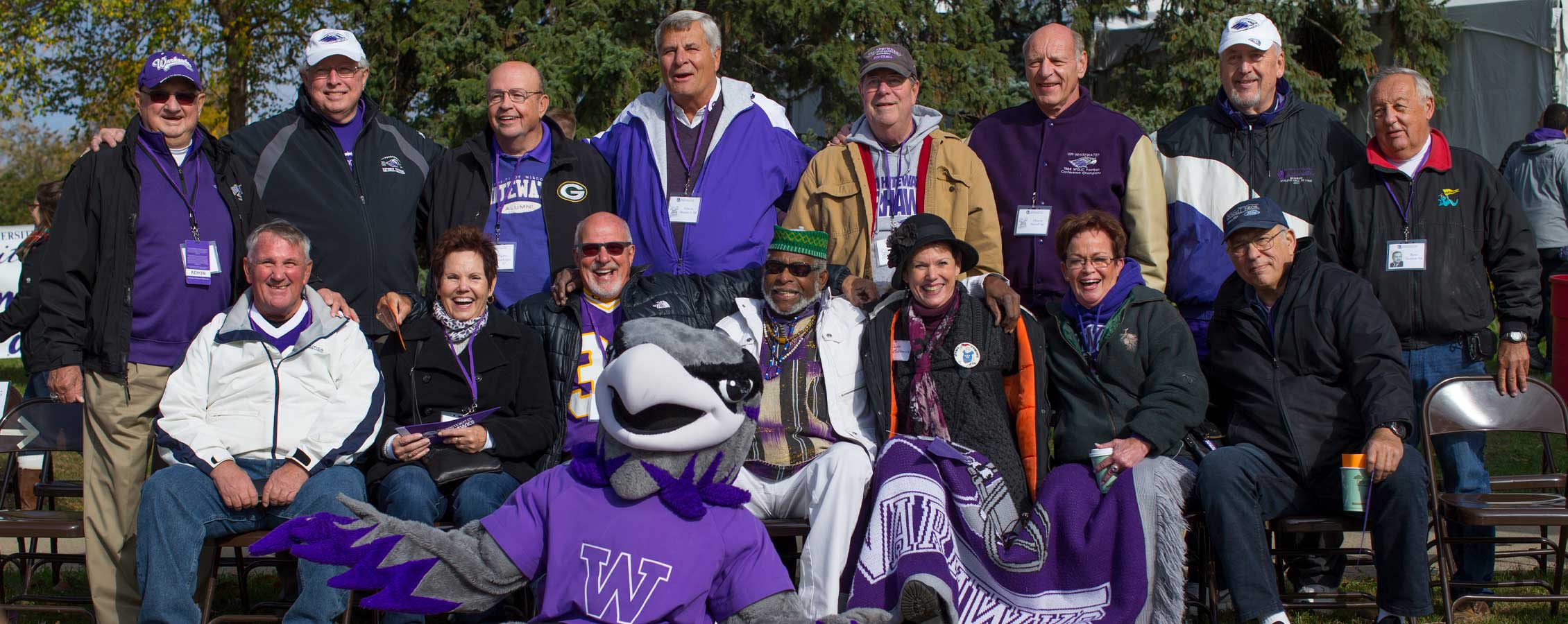Homecoming Alumni sit with Willie Warhawk.