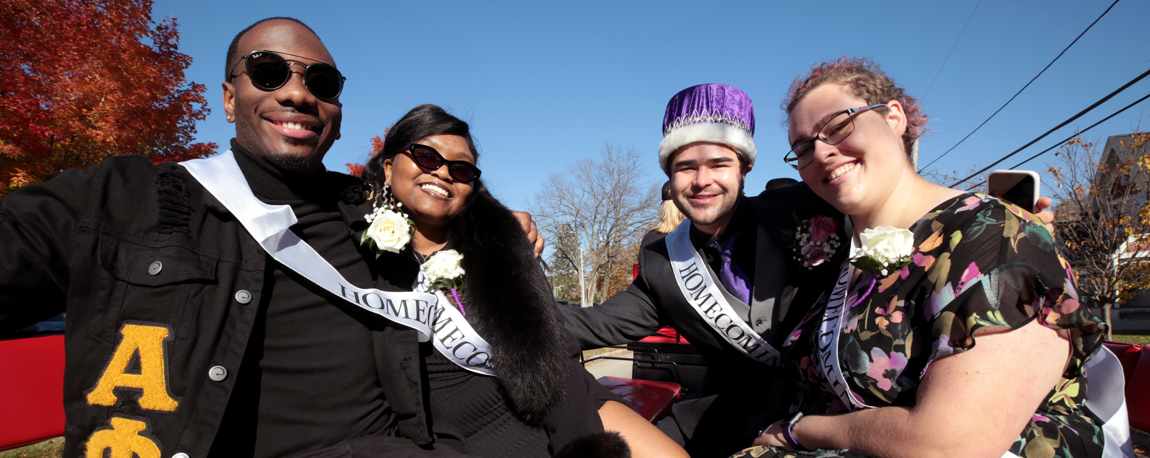 UW-Whitewater's Homecoming Court sits on a float at the parade.