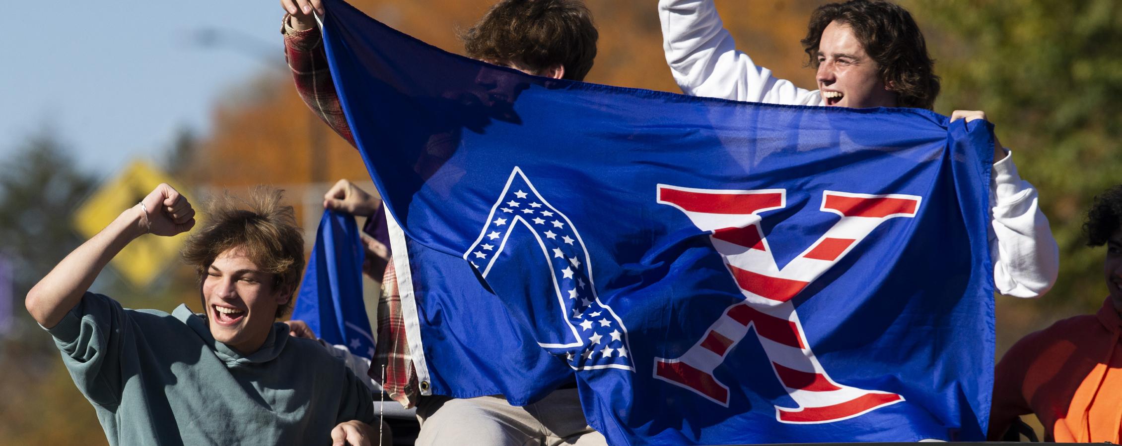 Students cheer on a float at the parade.