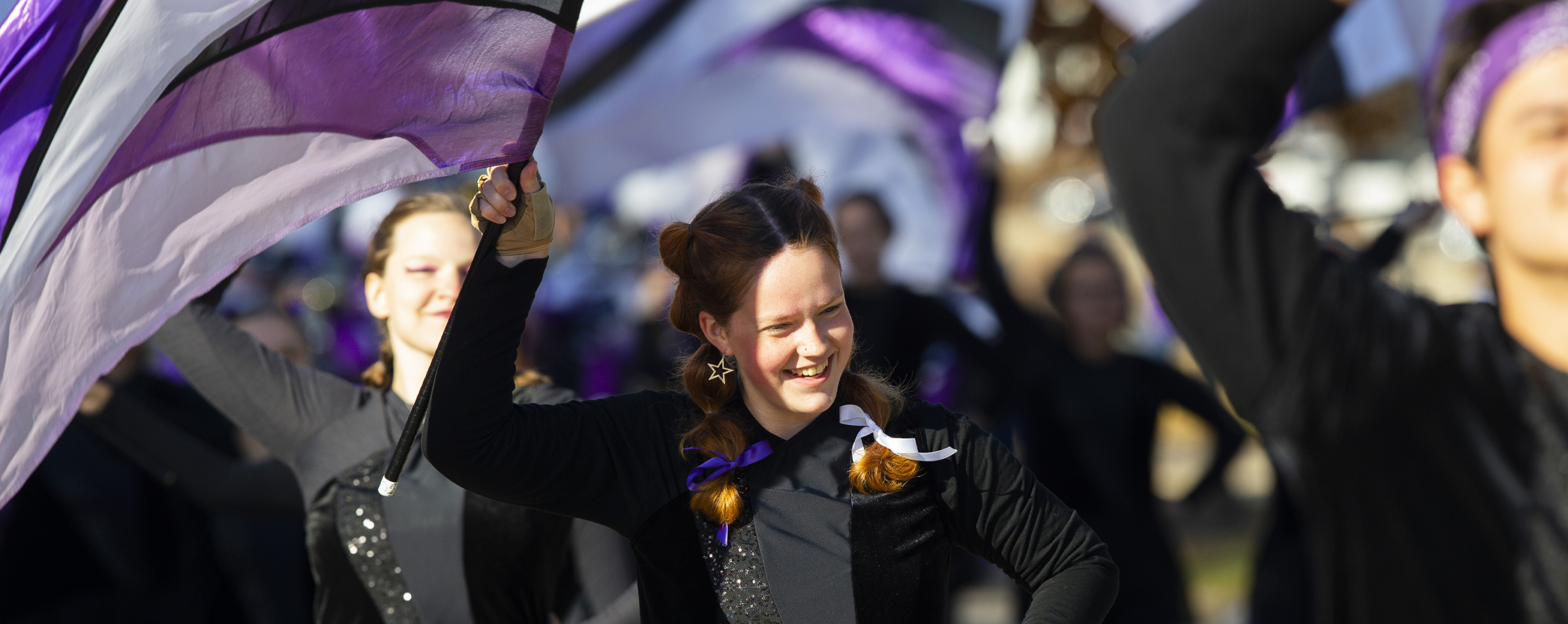 A member of the Color Guard smiles as she walks in the parade.