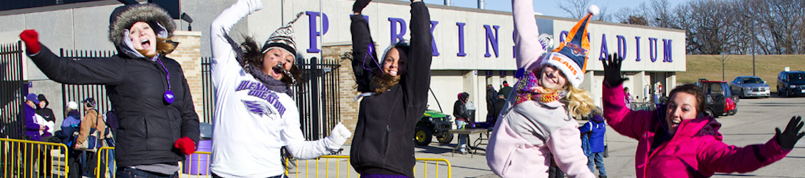 Students jumping in front of Perkins Stadium