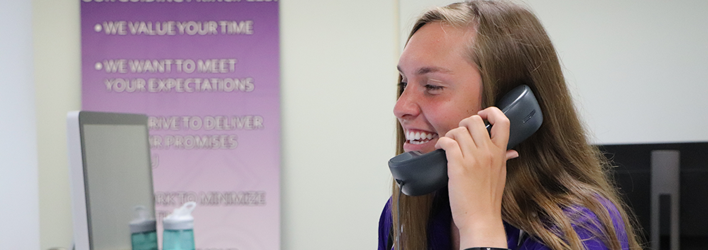 happy student employee answering a support call
