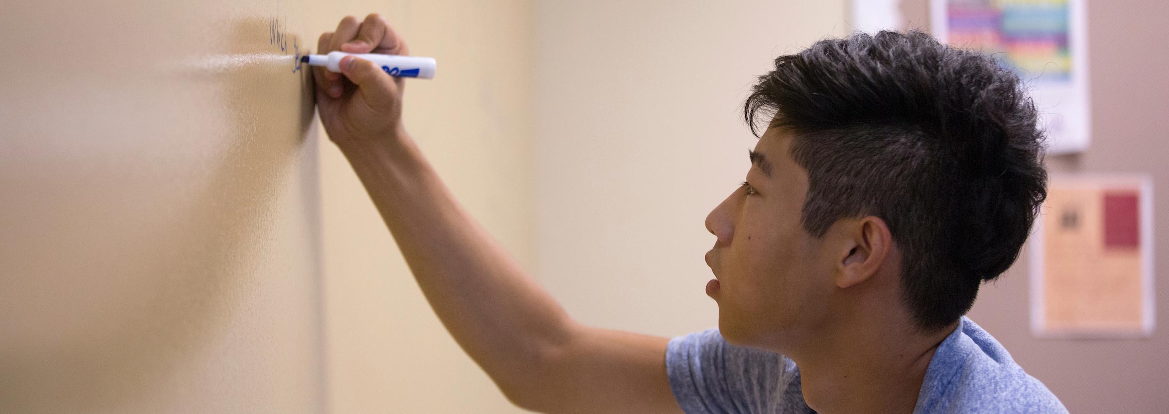 International student working on a white board at UW-Whitewater