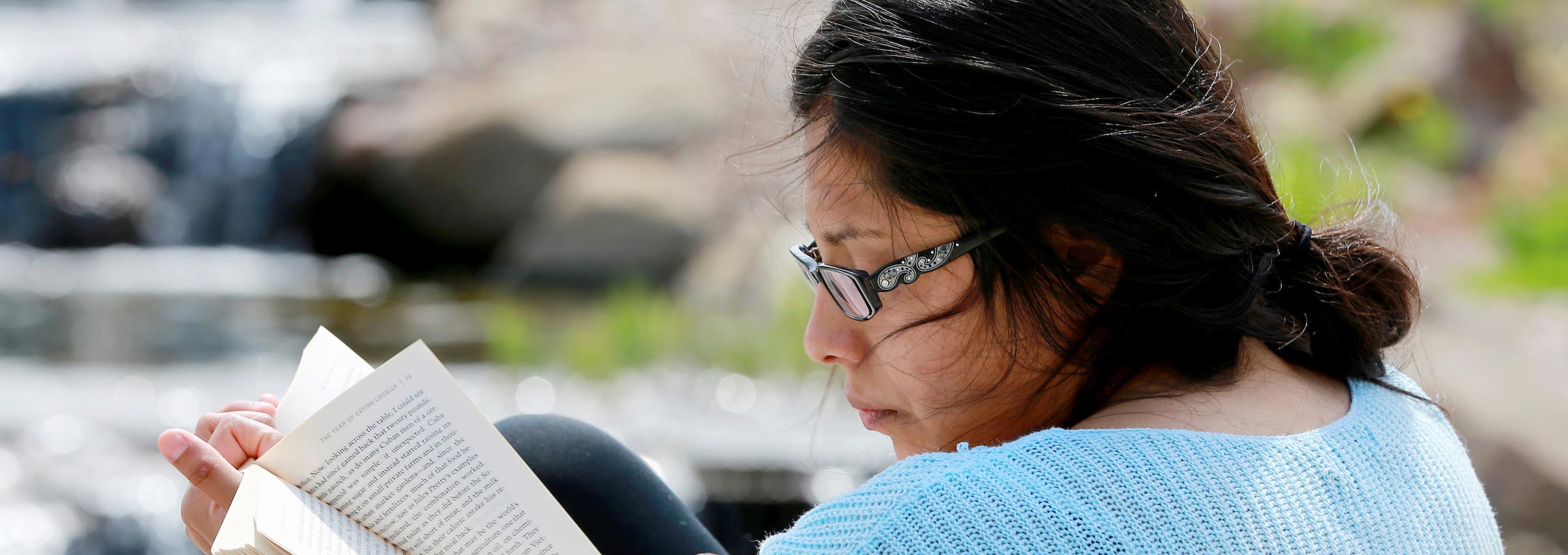 UW-Whitewater international student reading outside