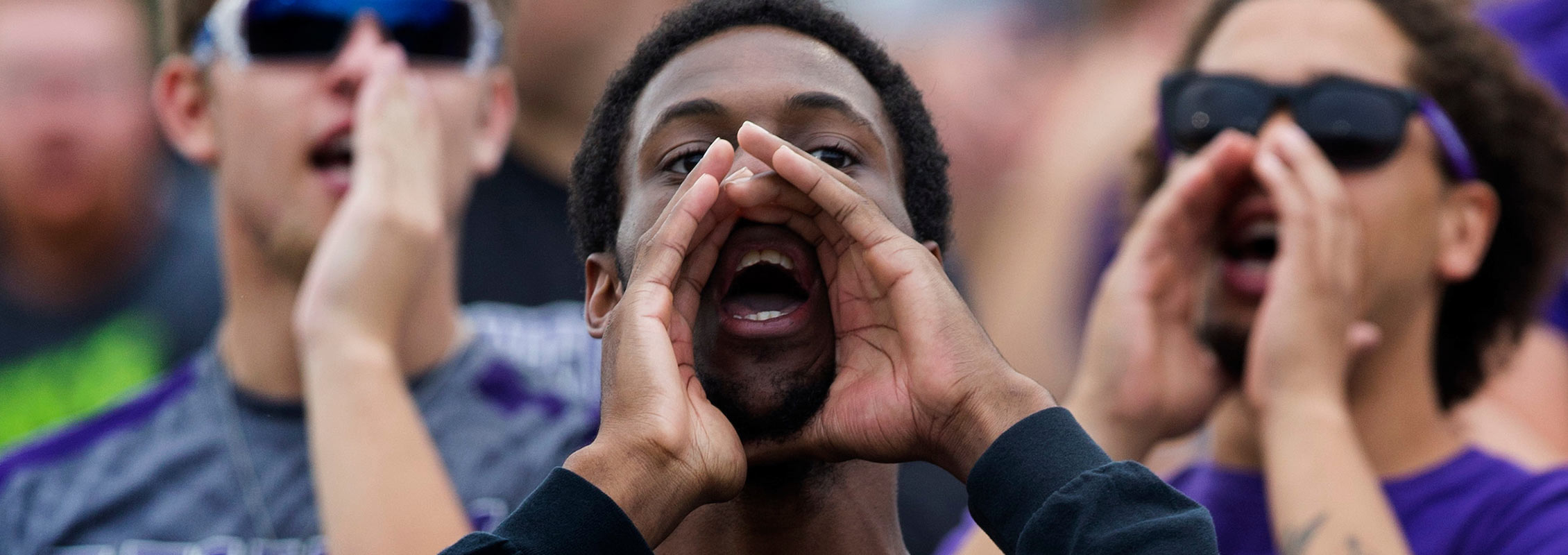 International student cheering at UW-Whitewater football game