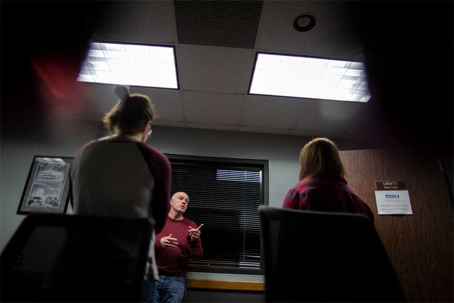 Jim Mead briefs two students in the Andersen Library studio.