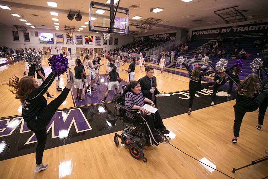 UWW-TV broadcasters on a basketball court.